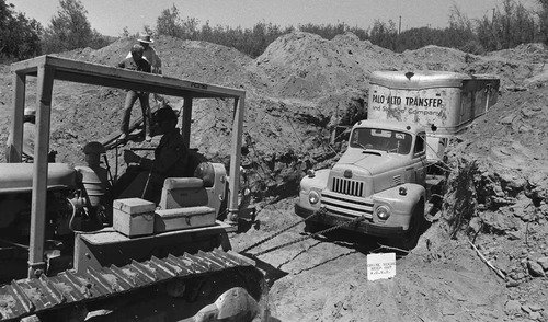 Workers remove the buried truck the kidnappers used as a bunker (Associated Press)