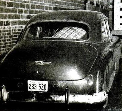 The Mossers' cark blue 1949 Chevrolet sedan after it was towed to a garage (Life)