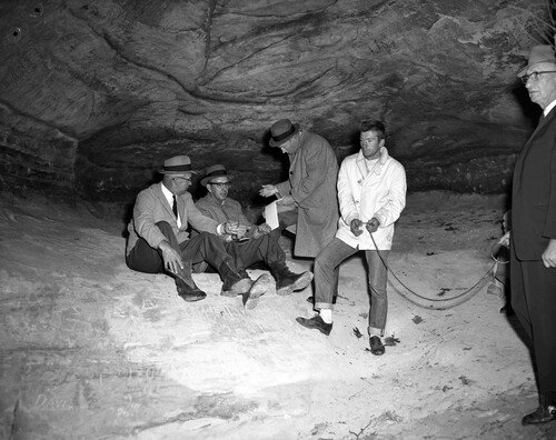 Chester Weger (white jacket) explains in November 1960 how he killed the three women and dragged their bodies into a cave in St. Louis Canyon (Joe Mastruzzo/Chicago Tribune)